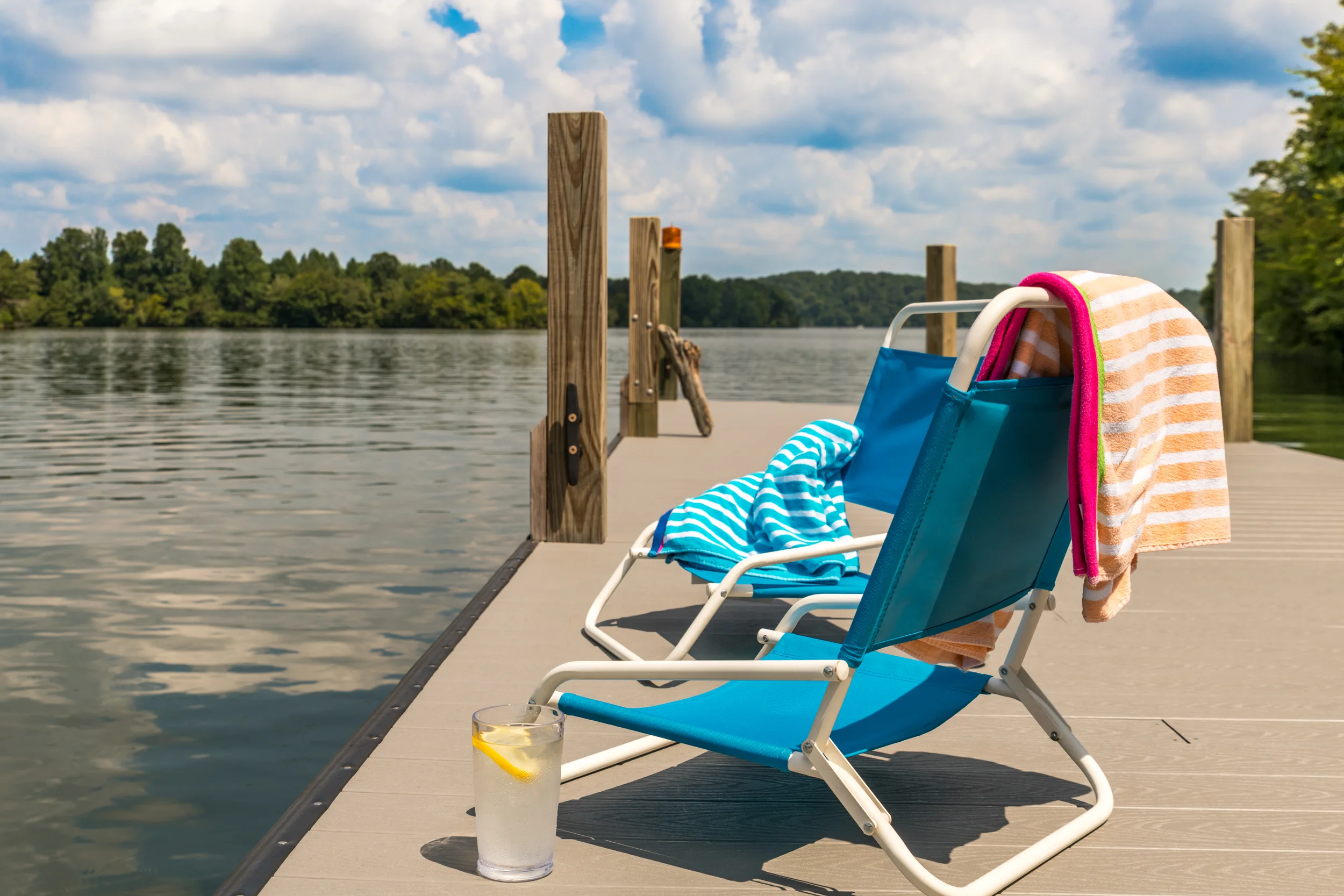Chairs, american flags, fishing poles and swimming gear on a dock in Soddy Daisy, Tennessee.