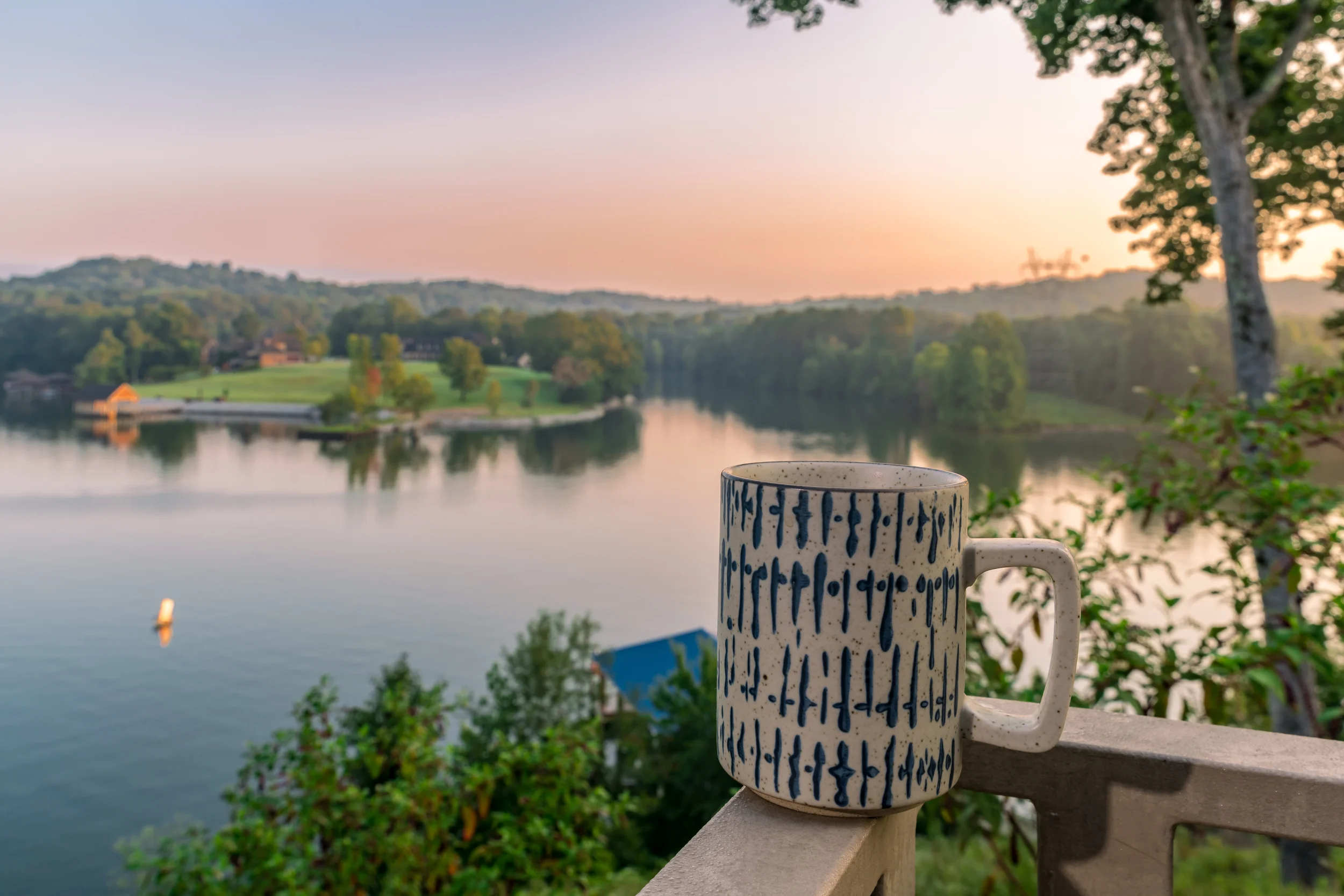 Scenic view overlooking river with a coffee cup on the deck at Riverside Bed and Breakfast in Soddy Daisy, Tennessee